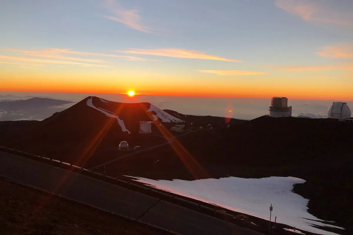 Top of a mountain at sunset on the water