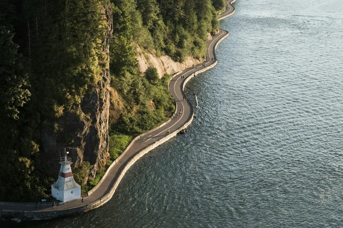 Aerial view of Stanley Park's winding coastal highway at daytime.