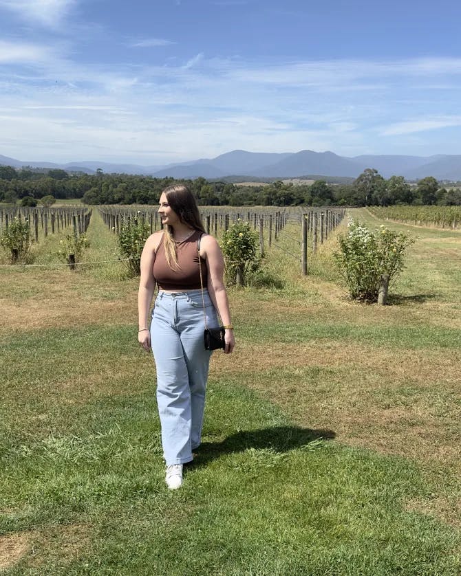 Advisor posing in an open field on a sunny day. 