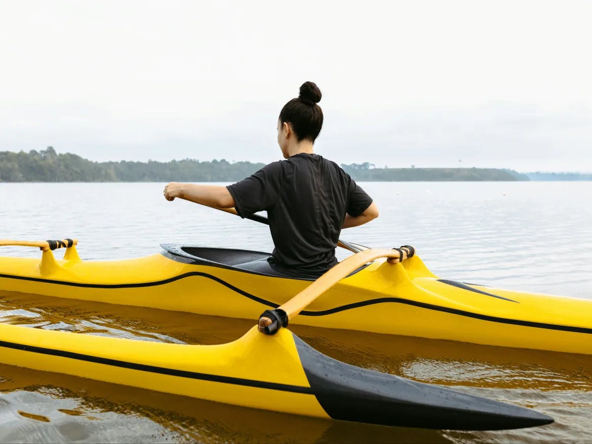 A woman kayaking on tranquil waters