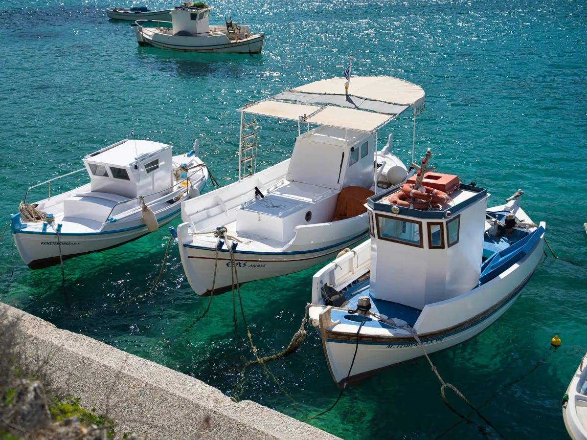 white-and-blue-boat-on-sea-paros-travel-guide