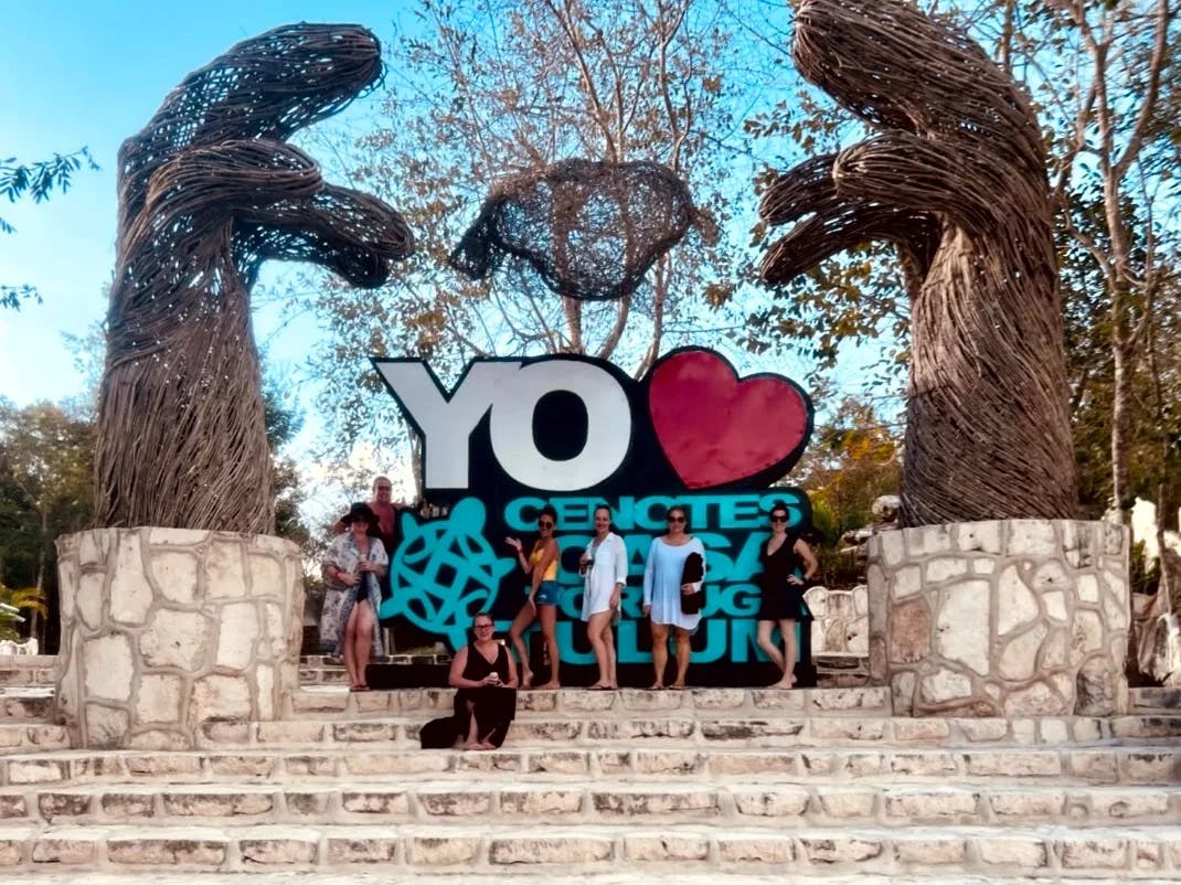 A picture of a group of girls posing at Cenotes entrance.