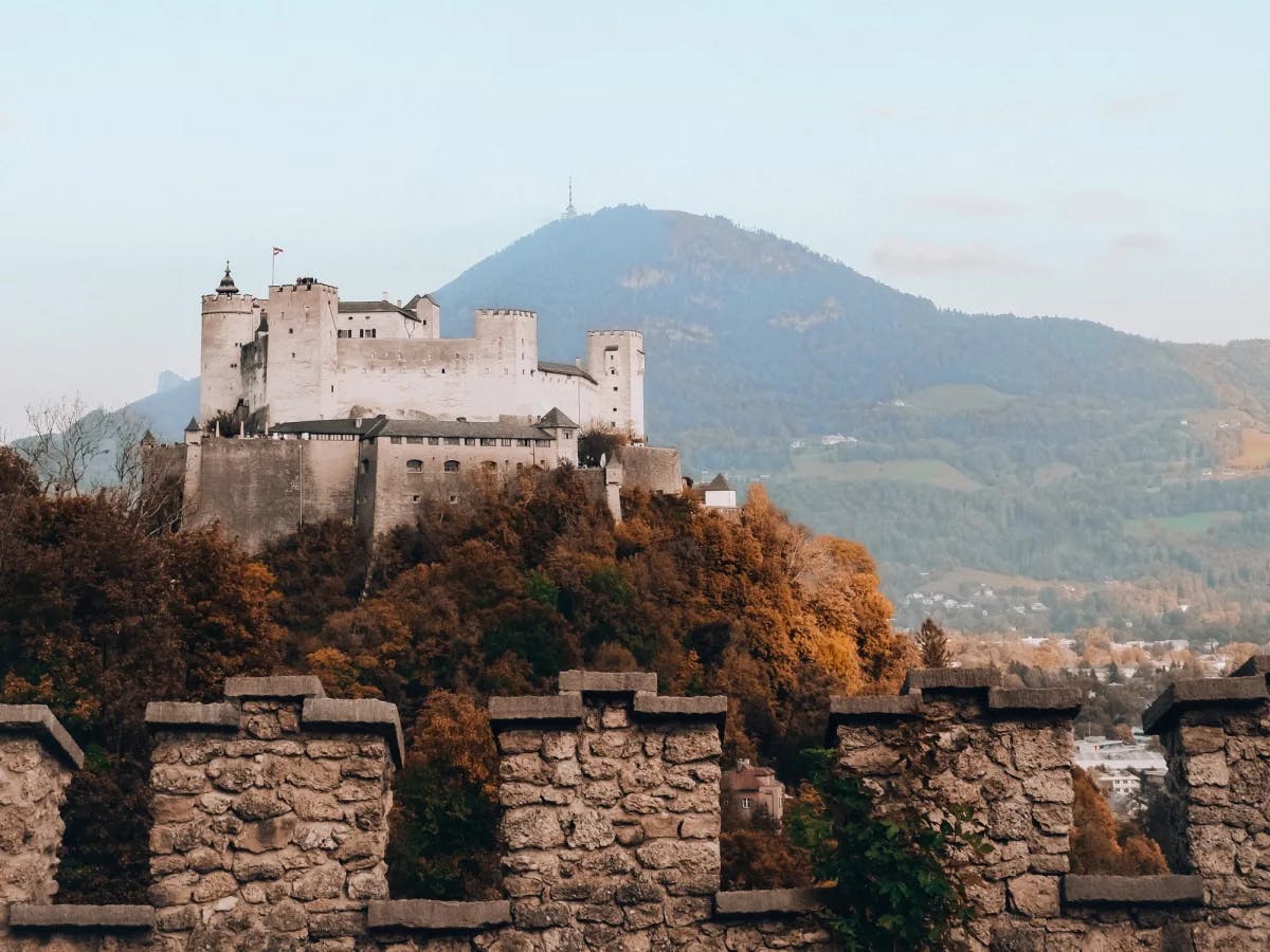 A fortress with mountains at the back. 