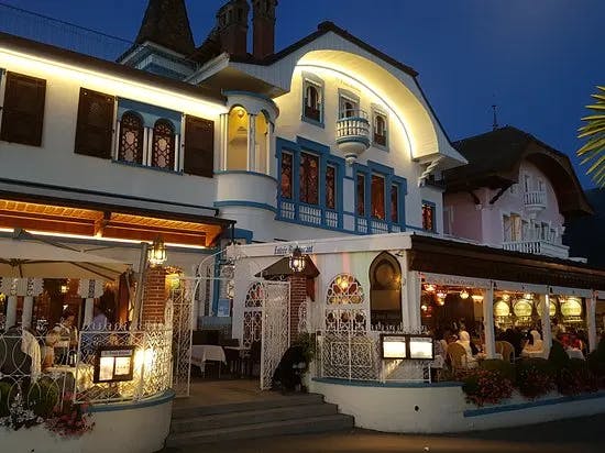 a busy, ornate restaurant illuminated at night