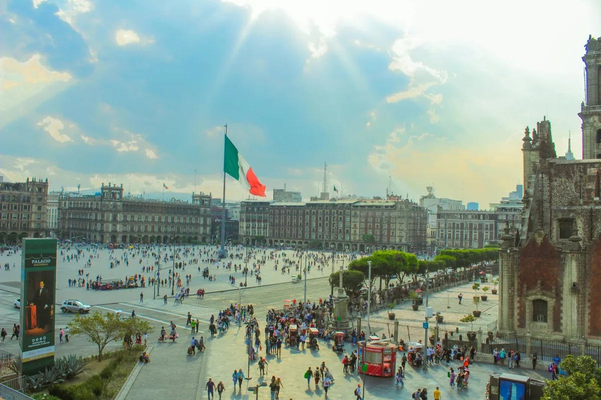 An aerial view of a large courtyard in a city with a big crowd of people