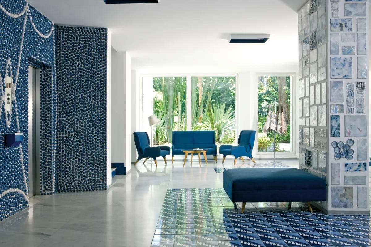 a fancy hotel lobby with blue furniture and blue-and-white tile