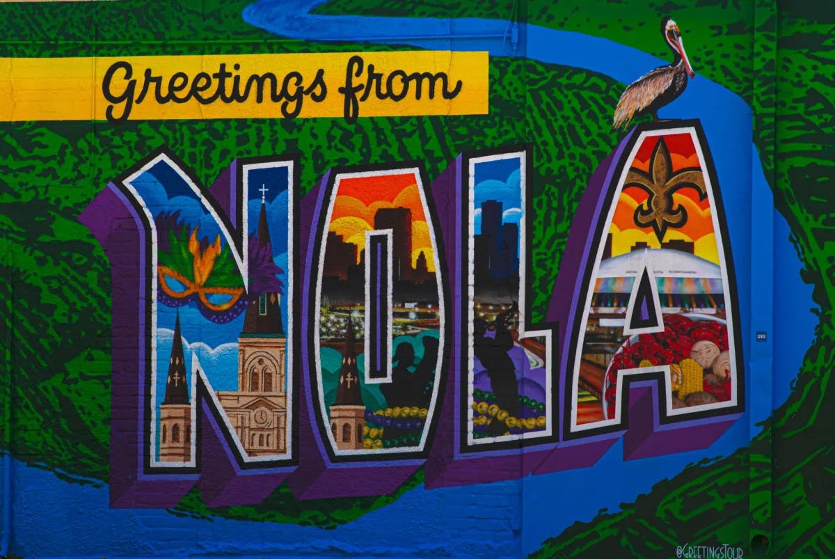 A colorful landmark saying Greetings from Nola. 