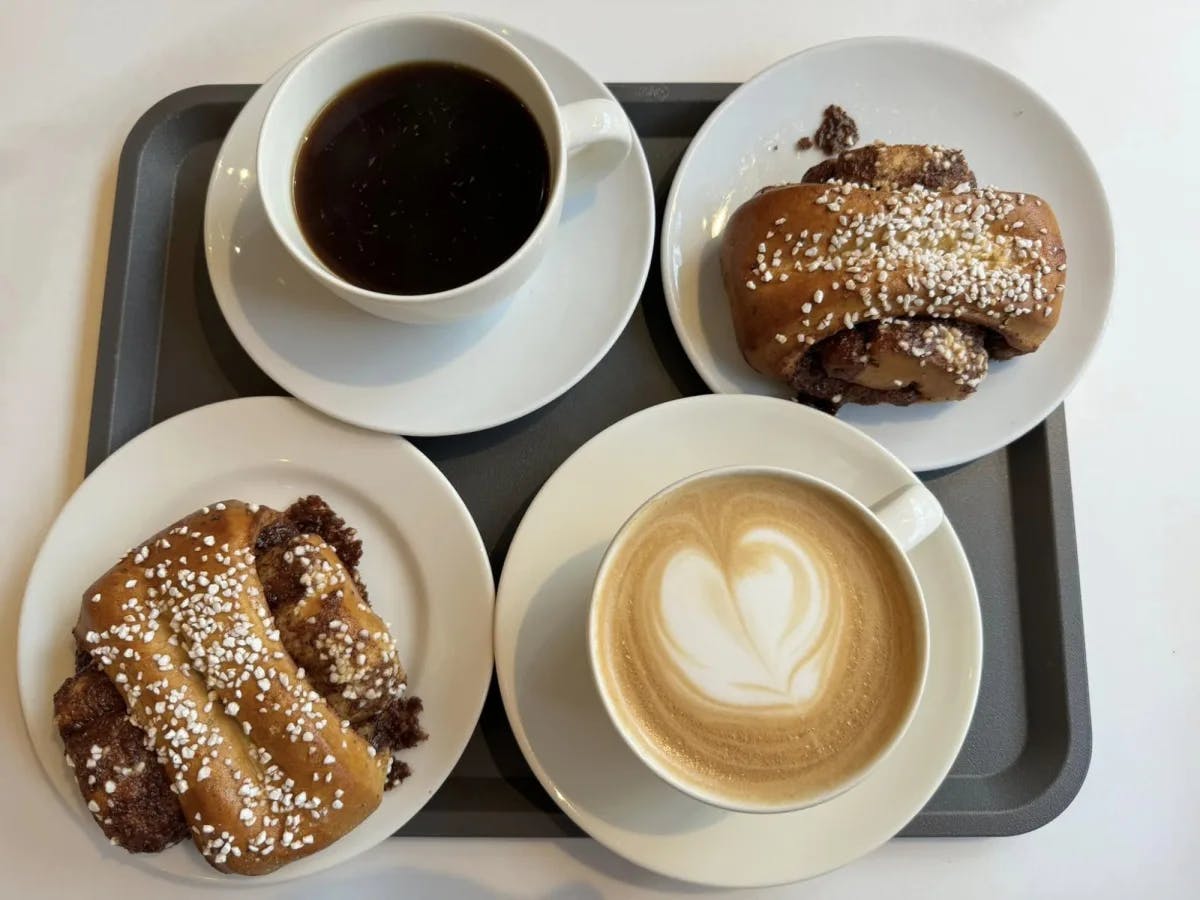 A tray with coffee and pastries. 