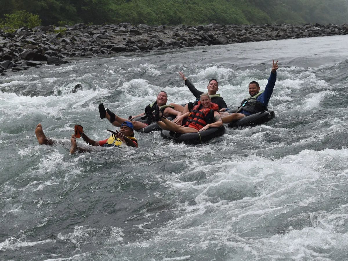 A picture of people river tubing on the Navua River during the daytime.