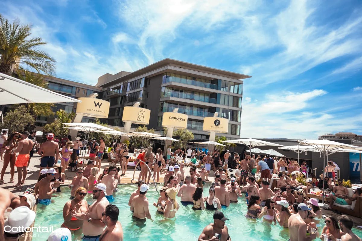 A pool party with a lot of people hanging out. 