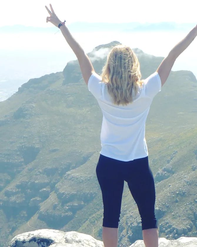 Travel advisor posing in front of mountain