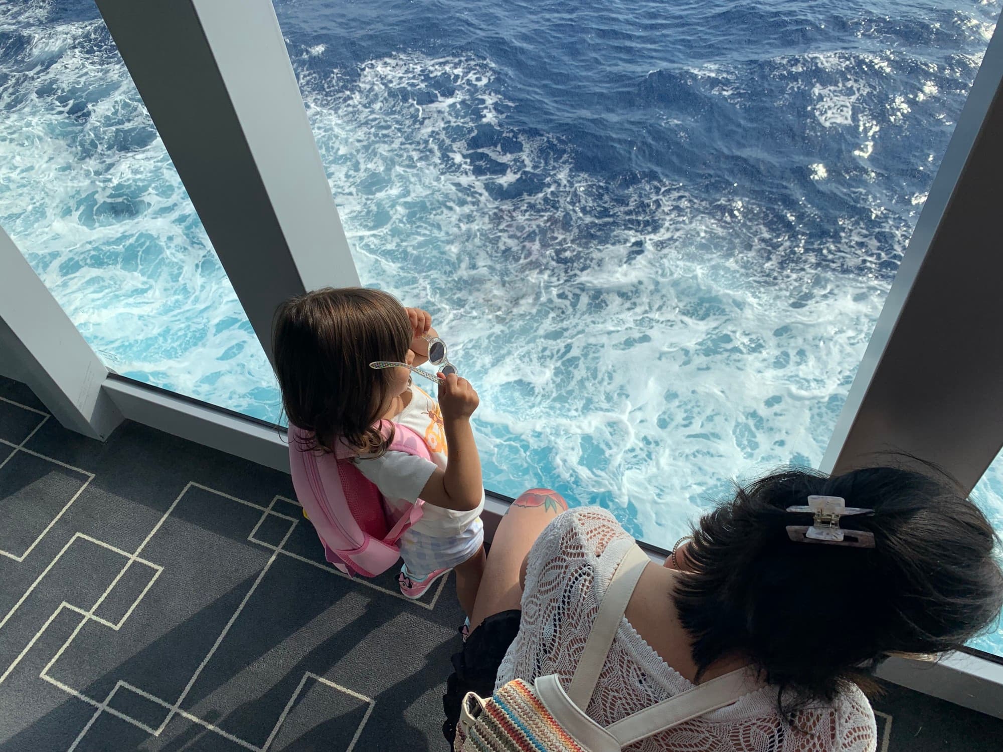 A little girl looking at the ocean on a cruise.