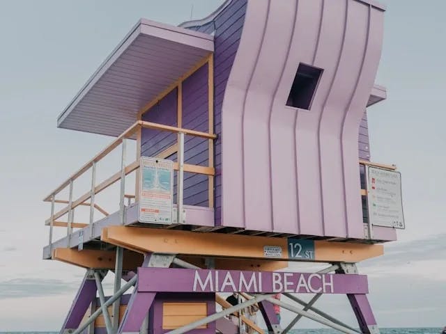 An elevated, lavender-colored life guard hut on Miami beach.