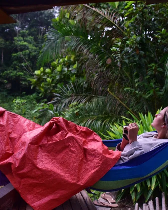 girl lying in a hammock in the jungle