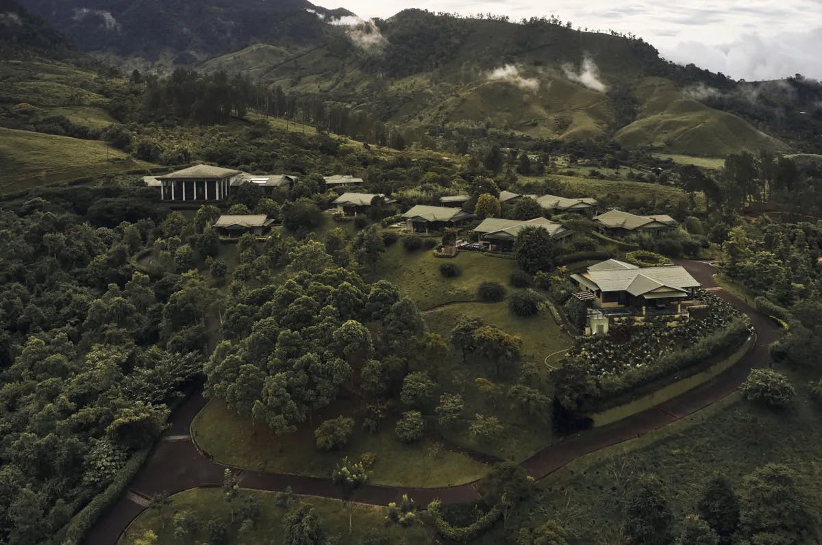 aerial view of green-roofed casitas on a jungly mountain in Costa Rica