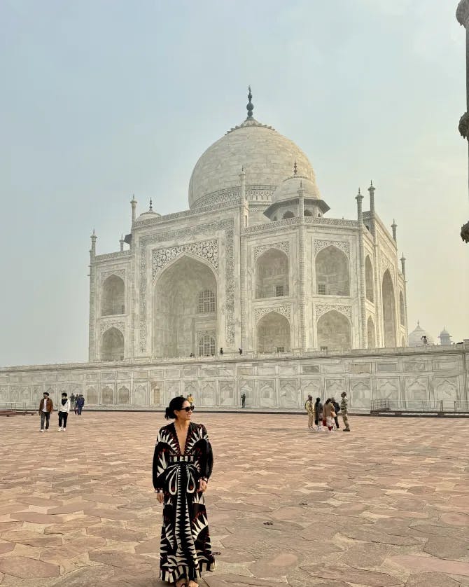 Lexi sporting a funky, yet elegant full-length dress in front of the Taj Mahal. 