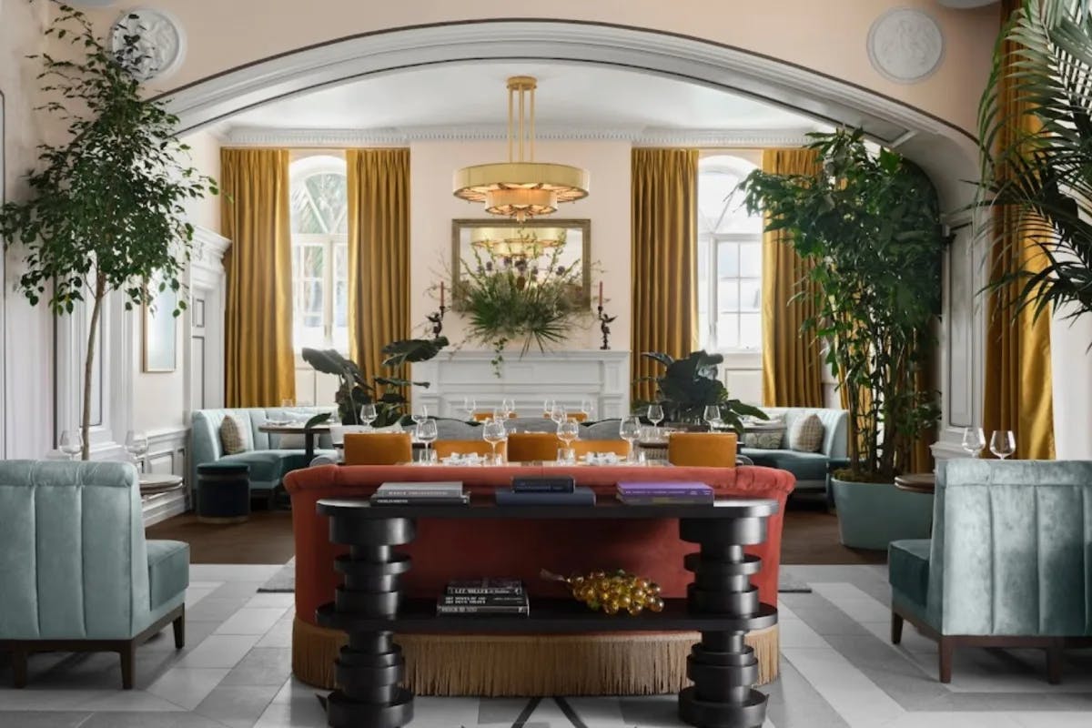 hotel lobby with blue and orange upholstery and star mosaic floor