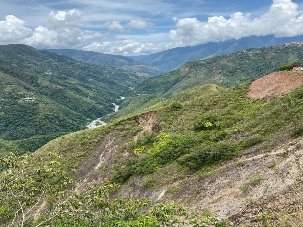 An aerial view of the green mountains during the daytime.