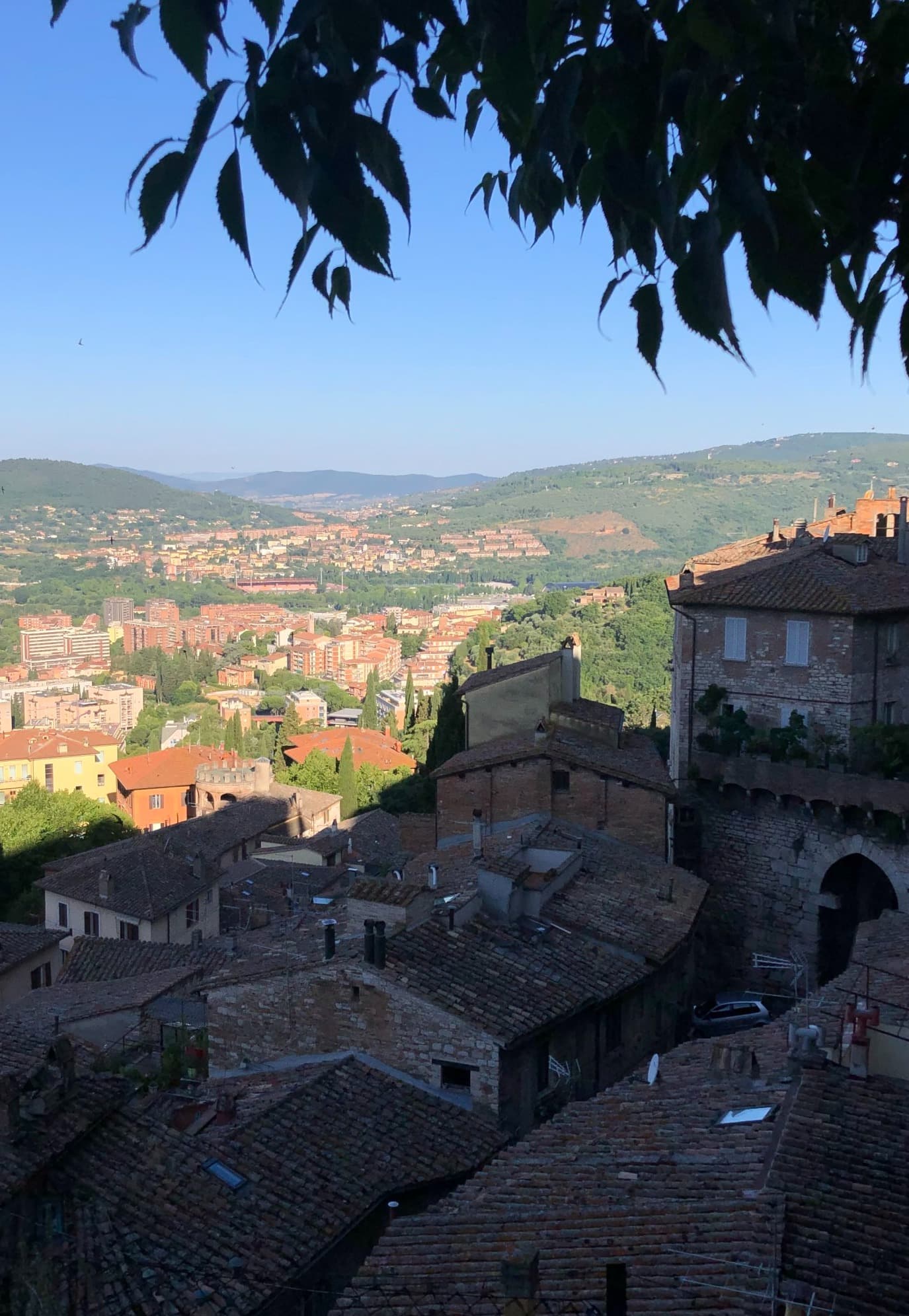 Hilltop view of a historic Italian city town.