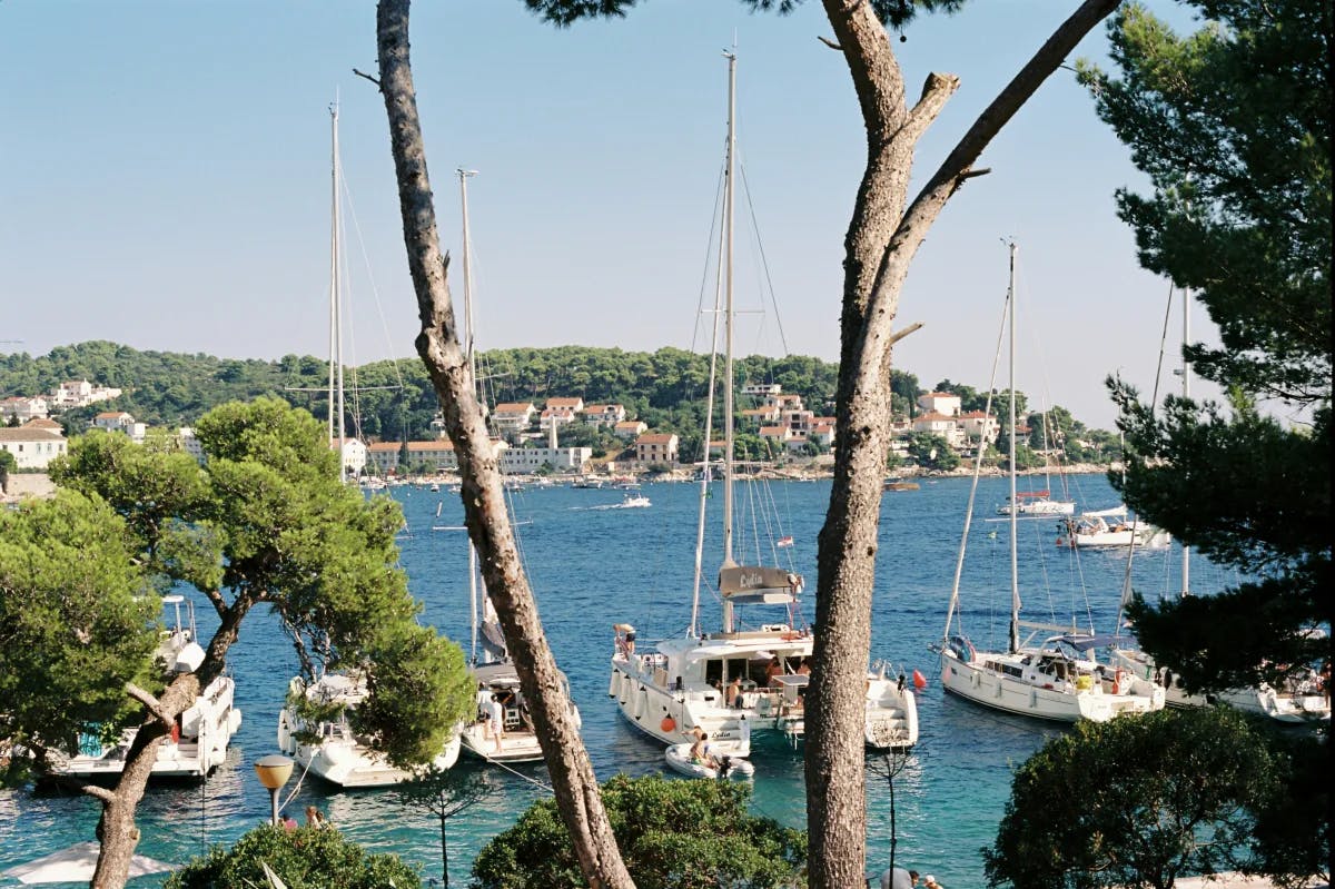 An aerial view of the Hvar Island with boats anchored to the dock.