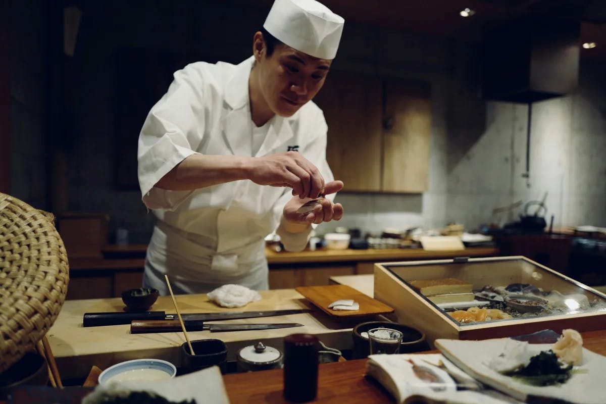 A chef making sushi in a kithen