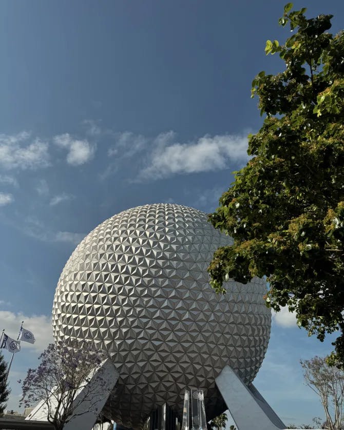 Image of a large white sphere-shaped building under blue skies