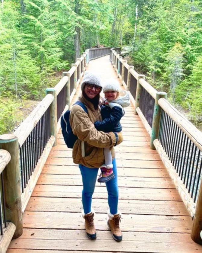 Posing for a picture with baby on a bridge