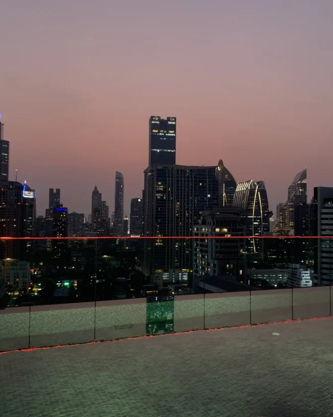 View from a rooftop of high rise city buildings lit up at night