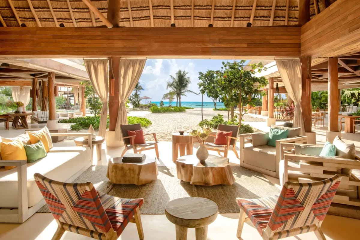 a beachside outdoor seating area overlooking the ocean