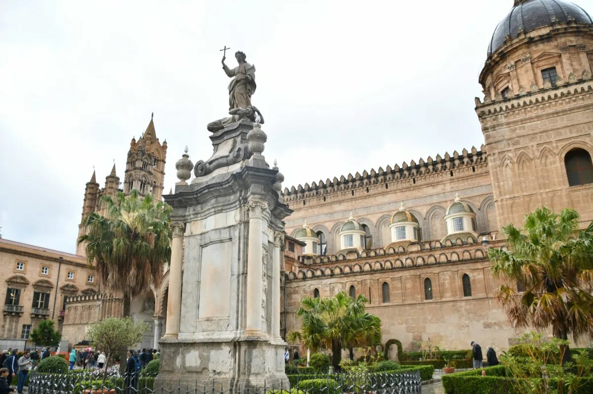 A cathedral building with a statue at front.