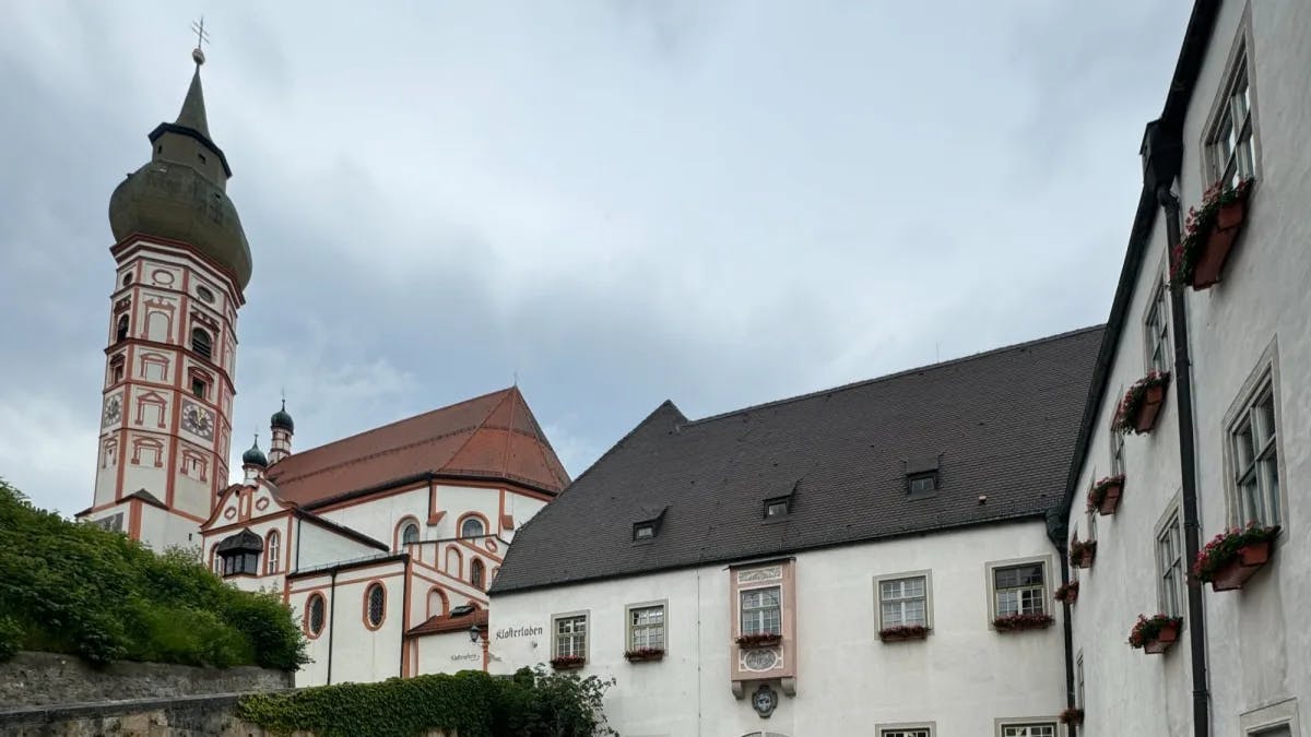 Stone pathway in front of white buildings.