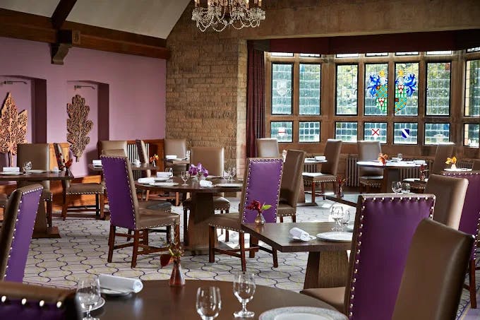 A Michelin-starred fine dining experience to remember at Bybrook at The Manor House as light filters through the stained-glass dining room.