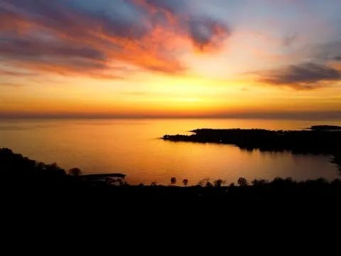 A stunning and multi-colored sunset over a silhouetted, Croatian coastline.