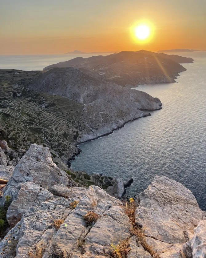 View of an ocean coast at sunset. 