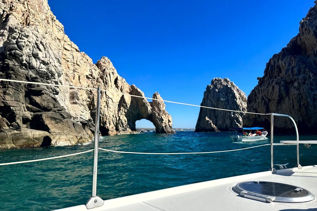 A picture of the sea and rock formations taken from a boat during the daytime.