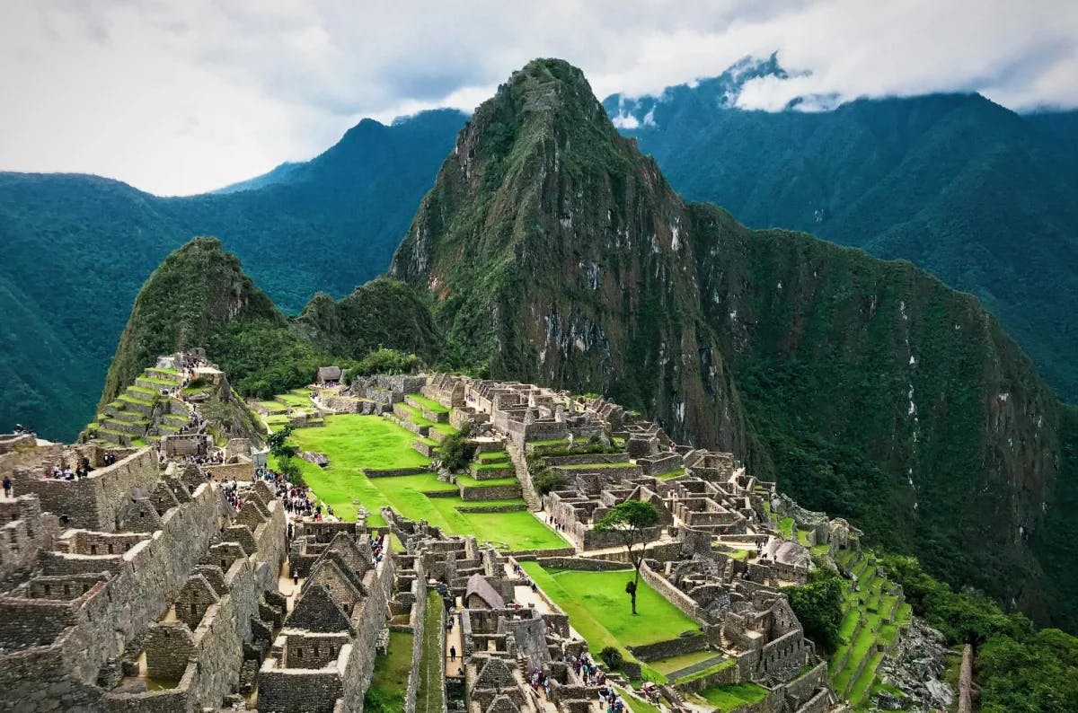 A closer aerial view of the ancient site of Machu Picchu on a sunny day.