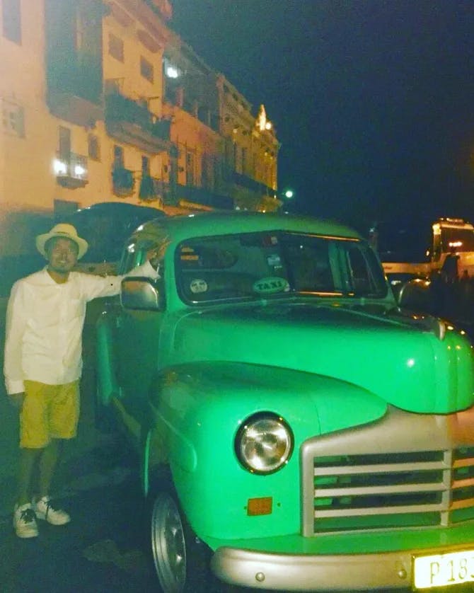 Posing with a green taxi