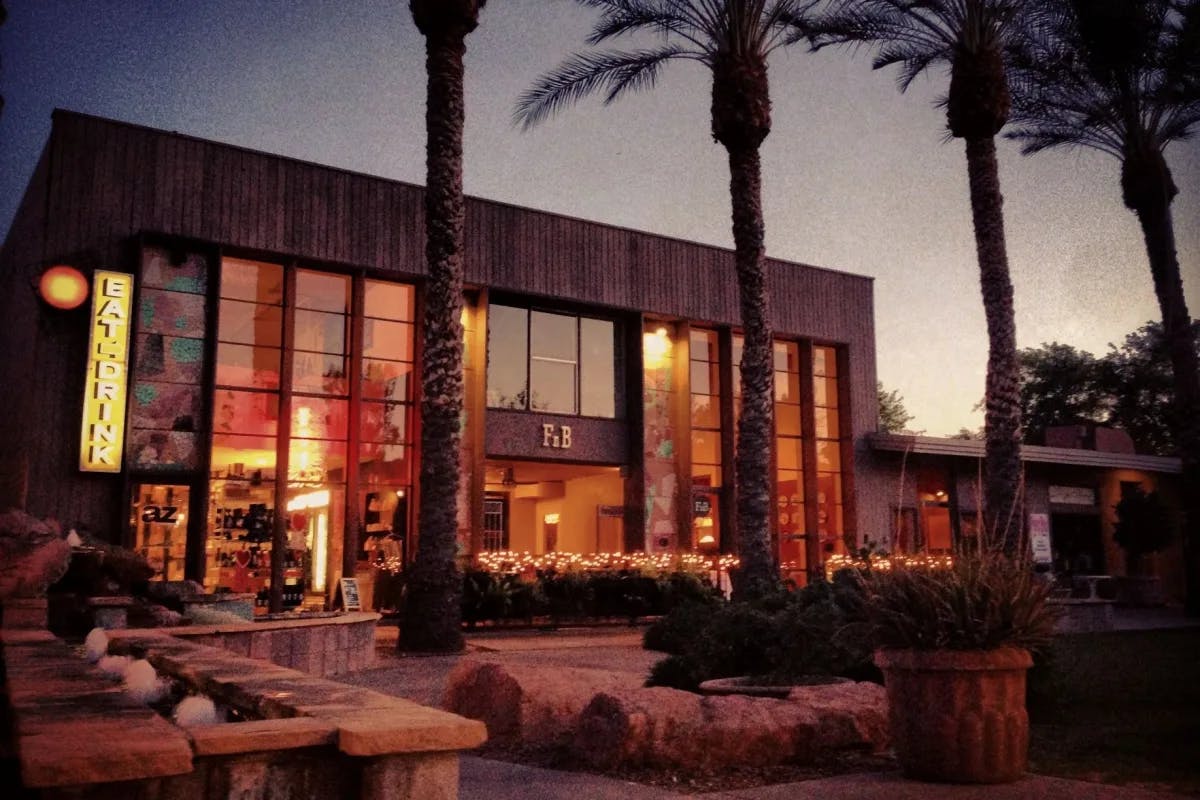 A large building with floor-to-ceiling windows during the nighttime