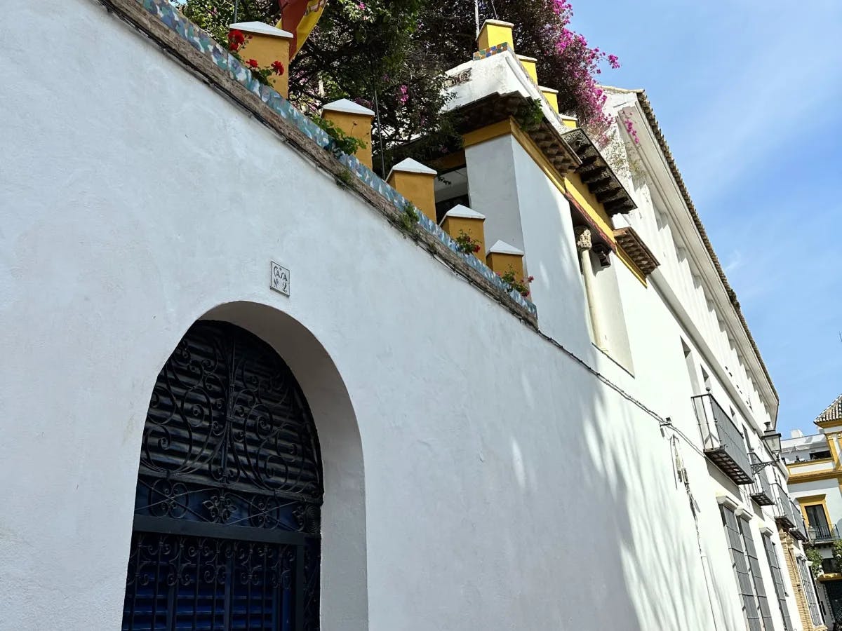 White wall with yellow top and black door.