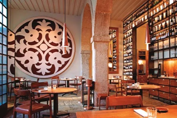 Dine at Alma, a high end restaurant at Lisbon with rich wooden furnishings and modern lighting. 