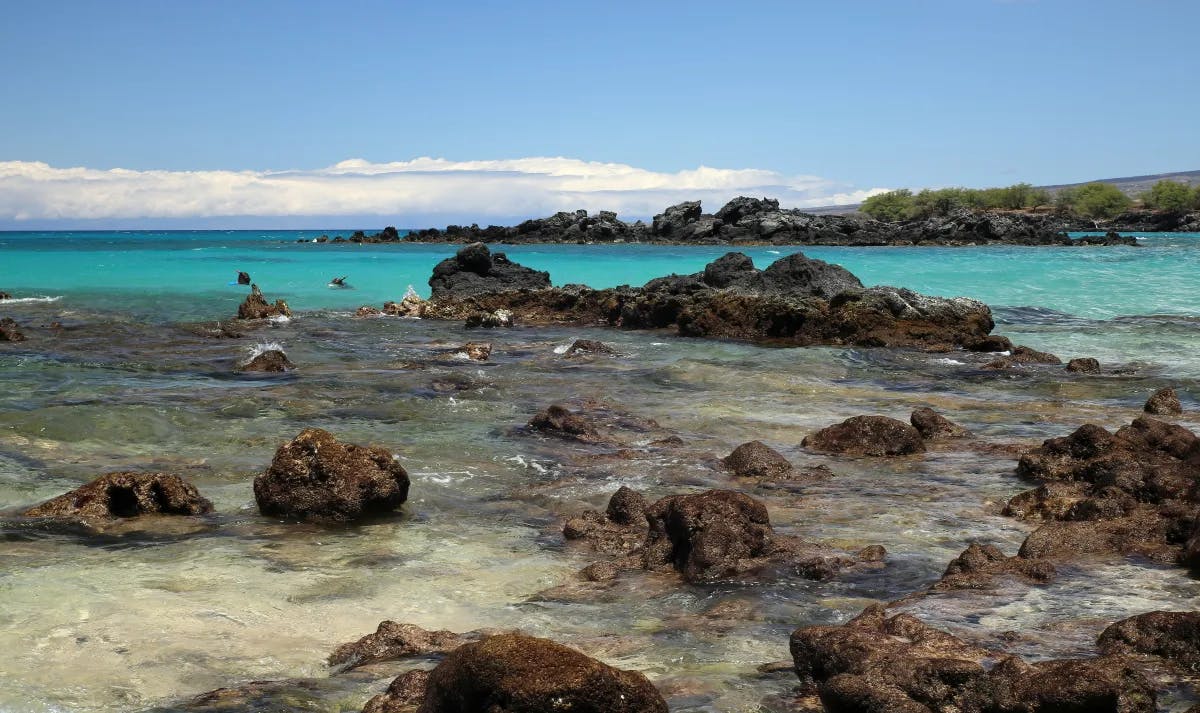 Shallow rock outcroppings next to the ocean.