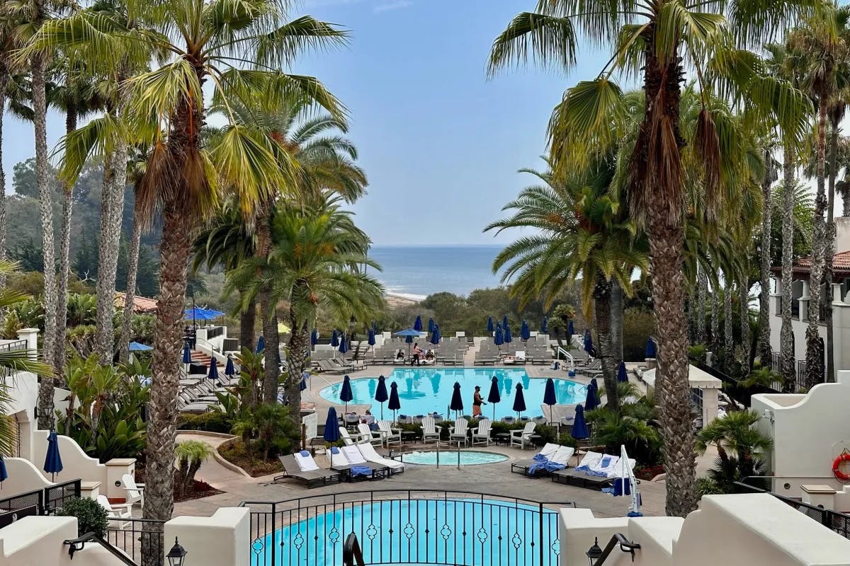 An aerial view of the resort of pool side during the day.