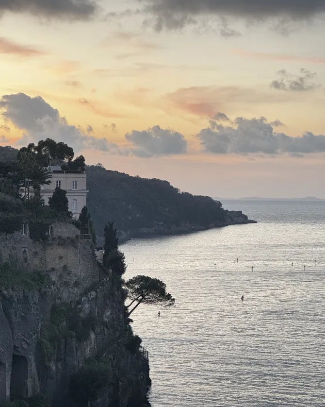 View of a coastline with tall cliffs at sunrise