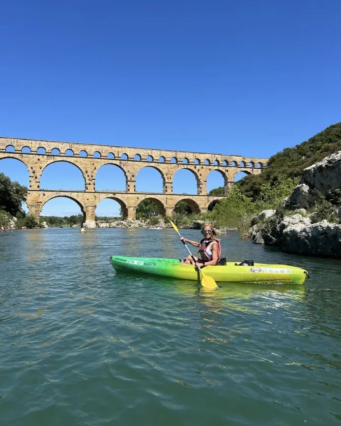 Kayak by a bridge.