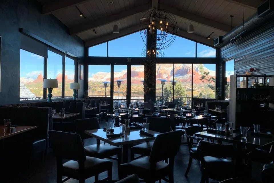 Indoor dining with a large window looking out on a mountain range