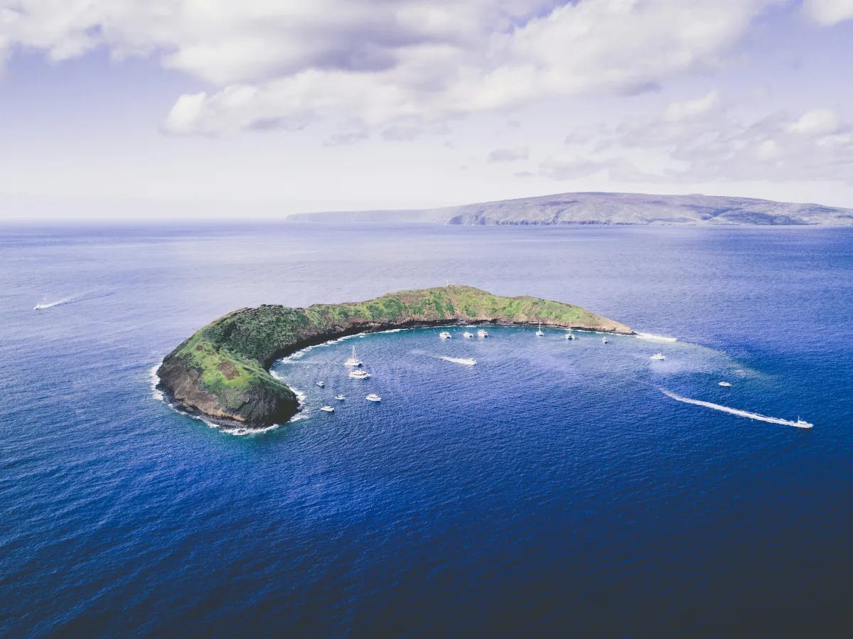 Molokini Crater, a small curved island surrounded by ocean.