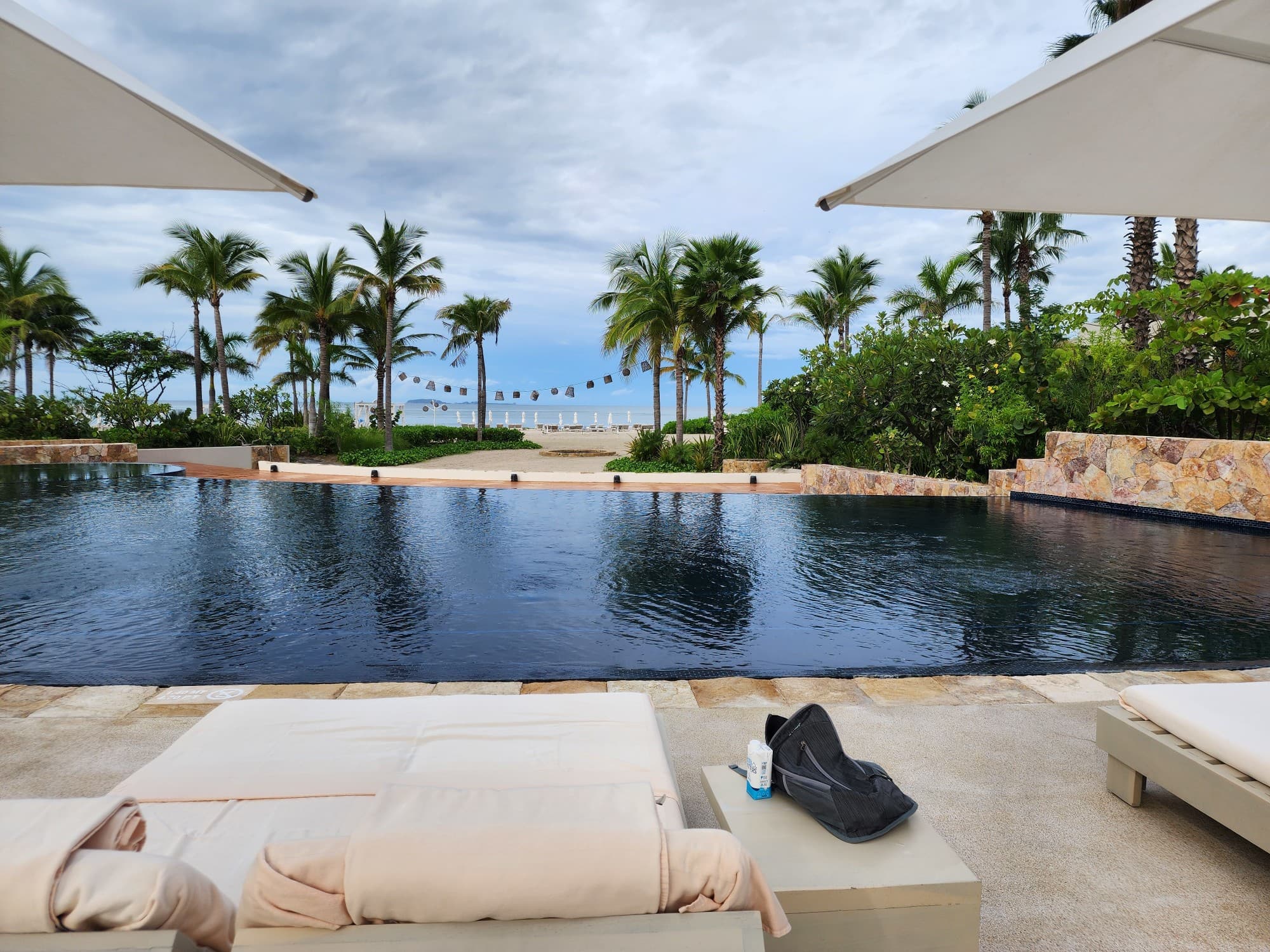 An outdoor swimming pool area during a cloudy day