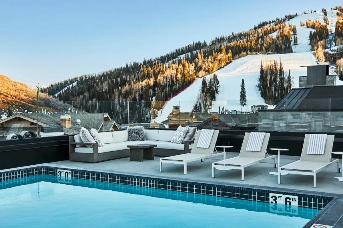 Chic rooftop lounge and pool area with the Deer Valley ski slopes in the background