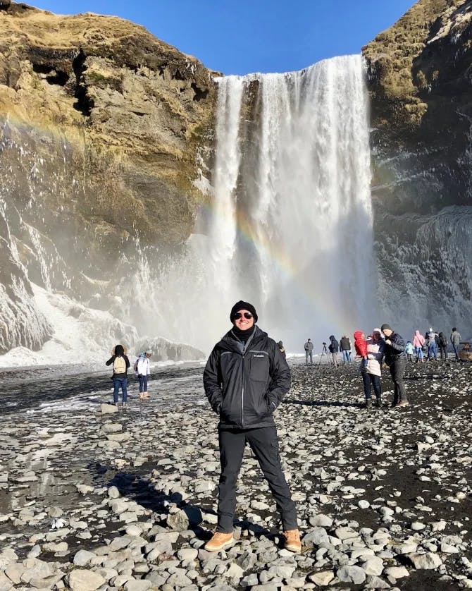 Posing for a photo by the waterfall