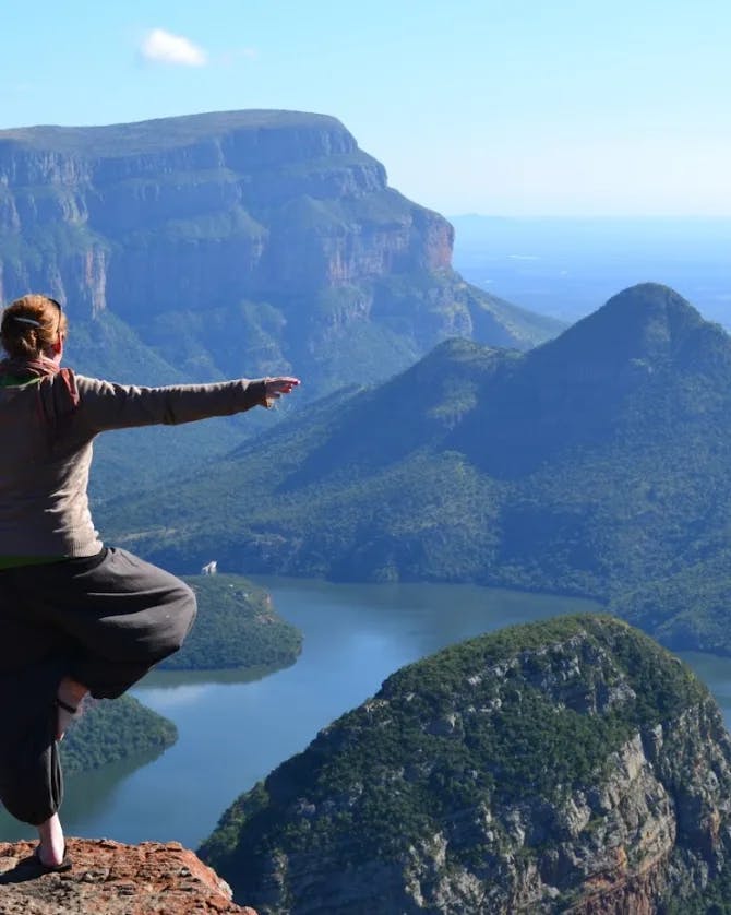 Travel advisor posing on a hill top